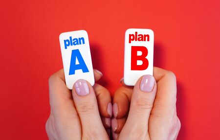 Plan A and plan B concept with blocks with text in a handsの写真素材