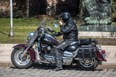 Vintage style motorcycle and dressed in leather motorcyclistの写真素材