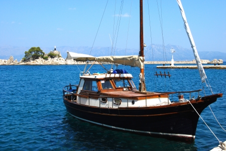 Small sailboat in Mediterranean port in summer dayの写真素材