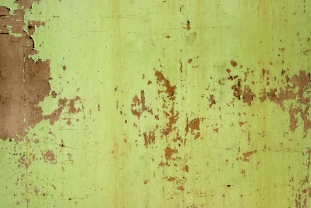 Weathered tin surface with peeling paint as background
