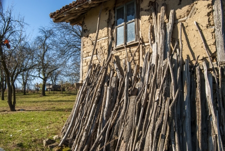 Old rural house with wood leaning against the wallの写真素材
