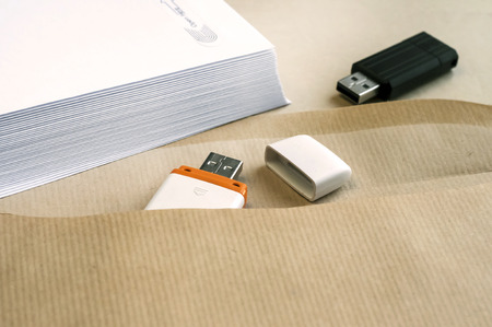Stack of white envelopes and USB flash memory drives as conceptの写真素材
