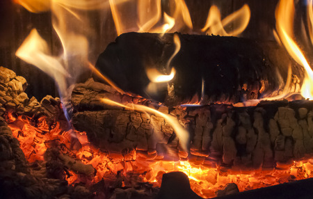 Wood burning in home fireplace closeup as backgroundの写真素材