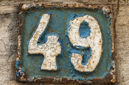 Old retro weathered painted cast iron plate with number 49