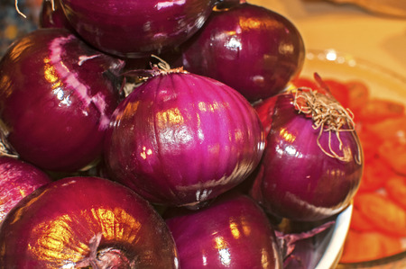 Peeled red onion bulbs closeup in kitchen backgroundの写真素材