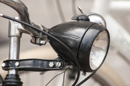 Black colored retro vintage bicycle headlight closeupの写真素材