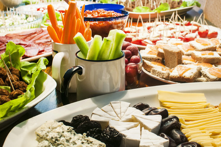 Home table with variety of appetizer dishes at partyの写真素材