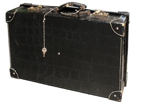 Retro vintage used suitcase of black patent leather isolated on white backgroundの写真素材