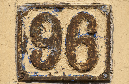 Old retro weathered cast iron plate with number 96の写真素材