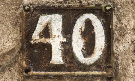 Old retro weathered cast iron plate with number 40