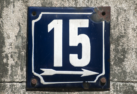 Weathered grunge square metal enameled plate of number of street address with number 15 closeupの写真素材