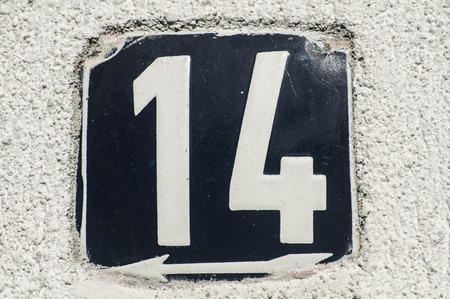 Weathered grunge square metal enameled plate of number of street address with number 14 closeupの写真素材