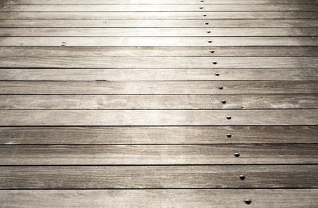 Surface of wooden boards with metal bolts in perspective as backgroundの写真素材