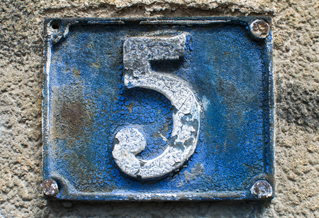Old retro weathered cast iron plate with number 5 closeupの写真素材