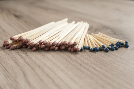 A pile of wooden safety long match sticks on wooden backgroundの写真素材