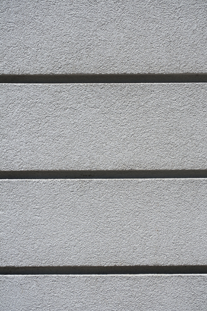 Detail of plastered house wall facade surface closeup as backgroundの写真素材