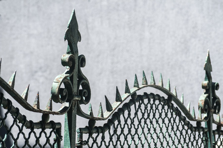 Decorative element of beautiful old vintage iron metal fence of urban house closeupの写真素材