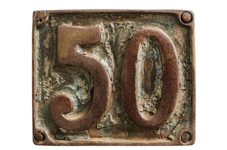 Old retro weathered cast iron plate with street number 50 closeup isolated on white backgroundの写真素材