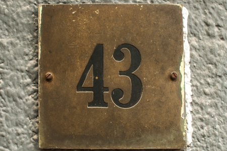 Old retro weathered cast iron plate with number 43 closeupの写真素材