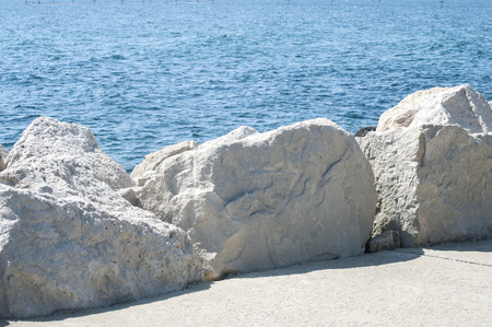 Seaside promenade with white stones on clear sunny summer dayの写真素材
