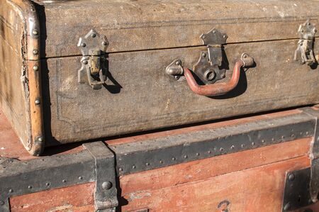 Old weathered retro vintage grunge suitcase handle and metal latch lock closeupの写真素材