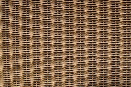 Natural brown rattan woven furniture surface closeup as background