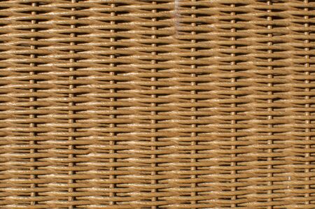 Natural brown rattan woven furniture surface closeup as backgroundの写真素材