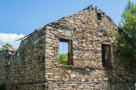 Old destroyed abandoned rural stone house closeupの写真素材