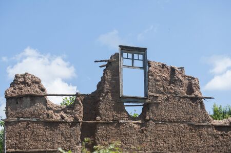 Old weathered rural countryside house clay brick wall closeupの写真素材
