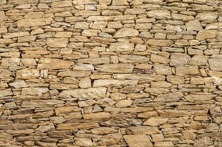 Old rural house rough sandstone wall closeup as stone backgroundの写真素材