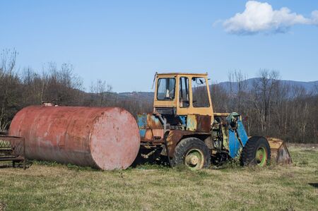 Old vintage bulldozer on countryside meadow in sunny day