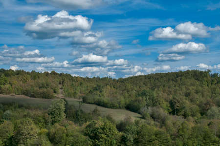 Countryside mountain landscape in sunny day with cloudy blue sky as natural backgroundの写真素材