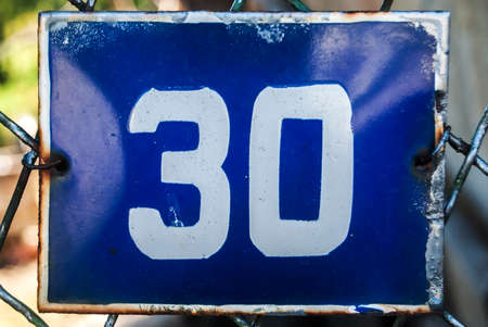 Weathered grunge square metal enameled plate of number of street address with number 30の写真素材