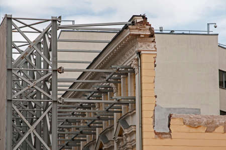 Strengthening of old facade wall of building with metal construction