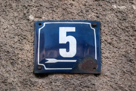 Weathered grunge square metal enameled plate of number of street address with number 5の写真素材