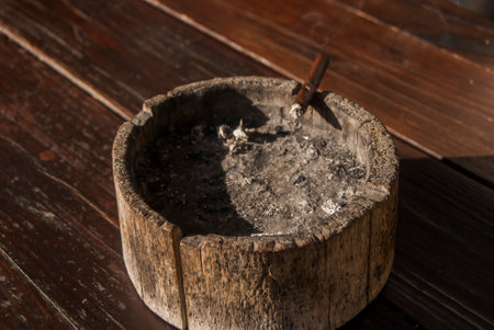 Wooden ash tray with cigarette butt closeupの写真素材