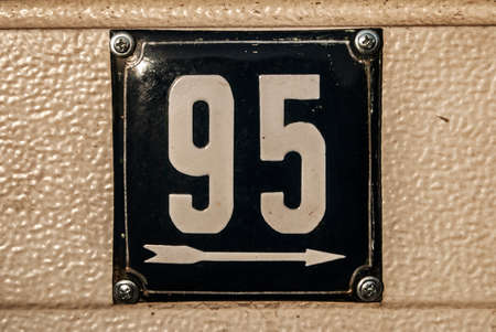 Weathered grunge square metal enameled plate of number of street address with number 95