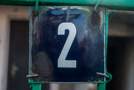 Weathered grunge square metal enamelled plate of number of street address with number 2の写真素材