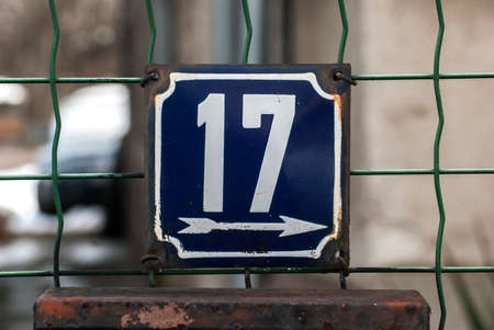 Weathered grunge square metal enamelled plate of number of street address with number 17の写真素材