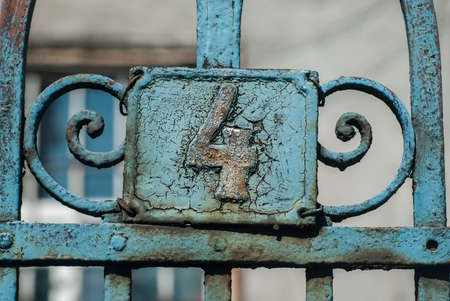 Old retro weathered cast iron plate with number 4 closeupの写真素材