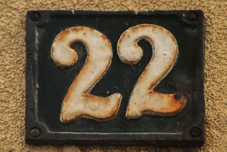Old retro weathered cast iron plate with number 22 closeupの写真素材