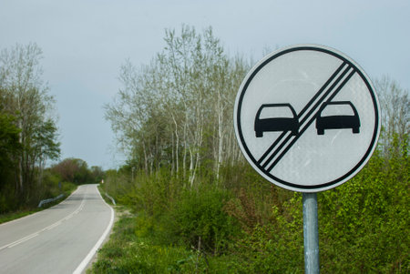 End of No overtaking road traffic sign closeup on country roadの写真素材