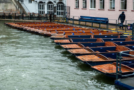 Punt flat bottom river wooden boats on river Cam waters in Cambridge