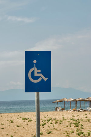 Disabled sign on sandy beach closeup on summer day backgroundの写真素材
