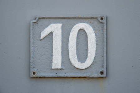 Old retro weathered cast iron plate with number 10 closeupの写真素材