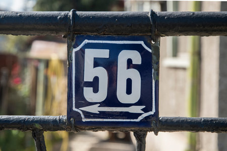 Weathered grunge square metal enameled plate of number of street address with number 56の写真素材