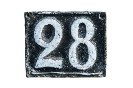 Old retro weathered cast iron plate with number 28 closeup isolated on white background