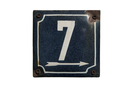Weathered grunge square metal enameled plate of number of street address with number 7 isolated on...