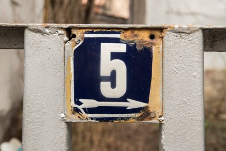 Weathered grunge square metal enameled plate of number of street address with number 5の写真素材