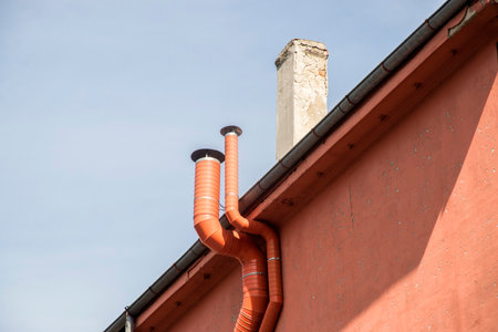 Air duct vent on the side wall of house closeup in clear sunny day